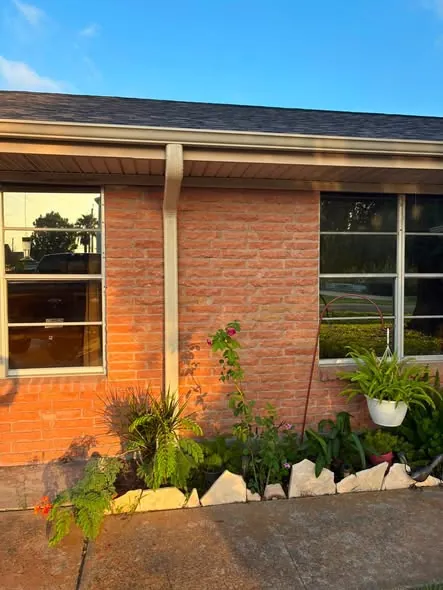 New gutter line running clean above brick windows